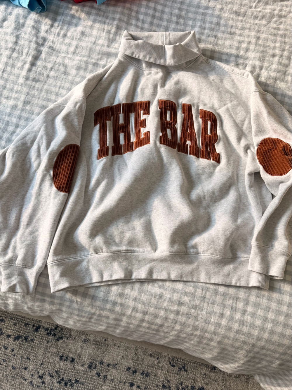 The Bar Cream Crewneck Sweater with Rust Appliqué
